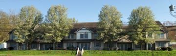 West Milton apartment for rent - a large house with trees in front of it