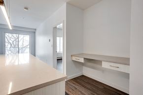 Edmonton apartment for rent - an empty kitchen with white cabinets and a white counter top