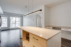 Edmonton apartment for rent - an empty kitchen with a large island in the middle