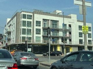Los Angeles apartment for rent - a busy city street with cars in front of a building