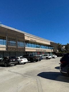 West Hollywood apartment for rent - a building with cars parked in a parking lot