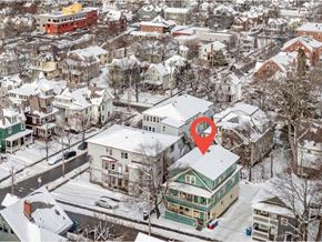 Burlington apartment for rent - A red marker is on a green house in a snowy residential area.