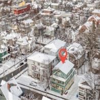 Burlington apartment for rent - A red marker is on a white building in a snowy city.