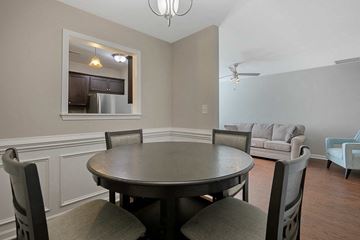 Fayetteville house for rent - a dining room with a table and chairs and a living room