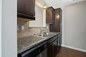 Fayetteville house for rent - a kitchen with granite counter tops and a stainless steel sink