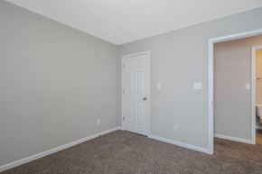 Fayetteville house for rent - a bedroom with a white door and a door to a closet