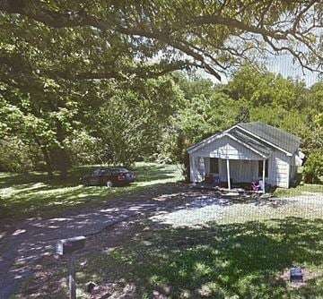Weaver house for rent - A car is parked in front of a house.