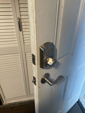 Washington apartment for rent - A white door with a silver handle and lock.