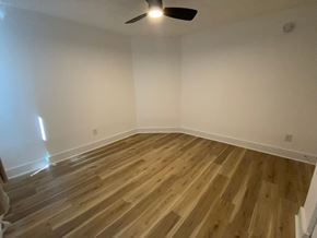 Louisville apartment for rent - A room with wooden flooring and a ceiling fan.