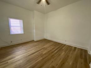 Louisville apartment for rent - A room with wooden flooring and a window with blinds.