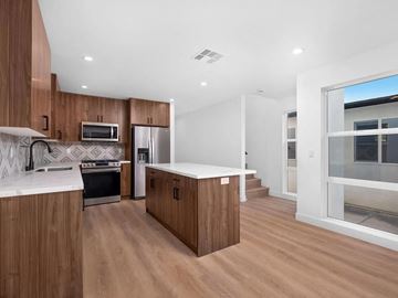 San Diego house for rent - a kitchen with wooden cabinets and a window