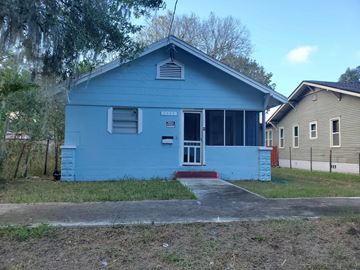 Jacksonville house for rent - a blue house with a sidewalk in front of it
