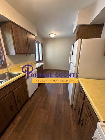 Stevens Point apartment for rent - A kitchen with wooden cabinets and a white refrigerator.