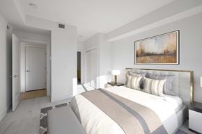 Qualicum Beach apartment for rent - A bedroom with a large bed and a painting on the wall.