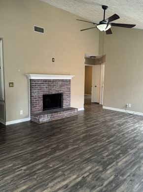 Montgomery house for rent - a living room with a fireplace and a ceiling fan