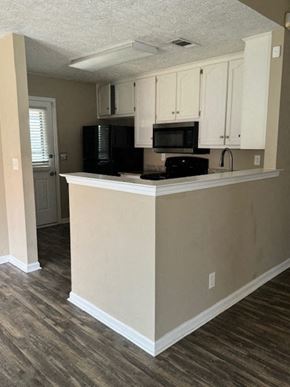 Montgomery house for rent - an empty kitchen with a counter and a microwave