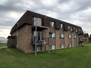 Grand Forks apartment for rent - a brick apartment building with balconies on the side of it