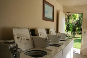 Anaheim apartment for rent - a row of washing machines in an outdoor laundry room