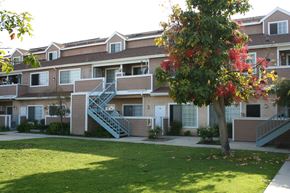 Anaheim apartment for rent - the outlook of an apartment building with balconies and a lawn