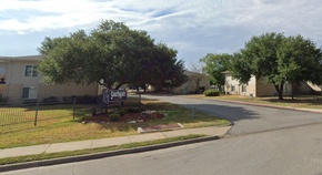 College Station apartment for rent - a street with a yard sign in front of a house