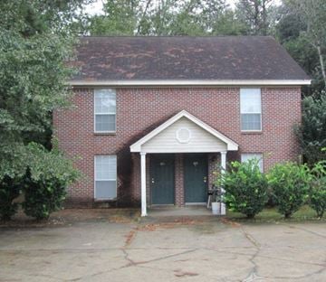 Purvis apartment for rent - the front of a brick house with a blue door