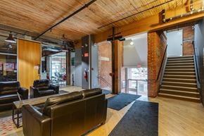 Edmonton apartment for rent - A large room with a staircase and a couch.