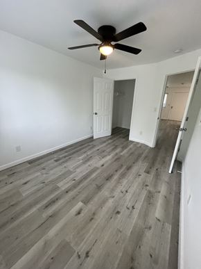 San Diego apartment for rent - A room with a ceiling fan and wooden flooring.