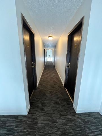 Grand Forks apartment for rent - a hallway with three doors and a carpeted floor and a door to a bedroom