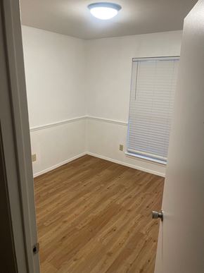 Arlington apartment for rent - a bedroom with wood flooring and a window