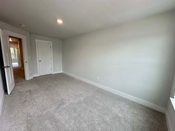 Moore house for rent - a living room with carpet and a door into a bedroom