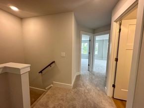 Moore house for rent - a entryway with a staircase and a hall to a bedroom and a door to
