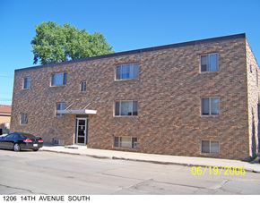 Grand Forks apartment for rent - a brick building with a car parked in front of it