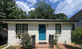 Atlanta apartment for rent - A white house with a blue door numbered 154.