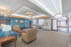 Saint Paul apartment for rent - a spacious waiting room with chairs and tables in a hospital