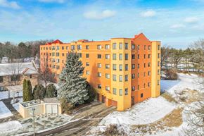 Saint Paul apartment for rent - a large orange apartment building in the snow