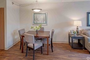 Saint Paul apartment for rent - a dining room with a table and chairs and a couch