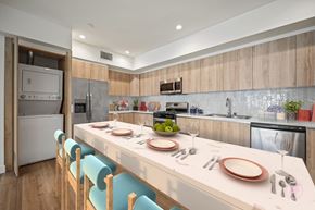 Los Angeles apartment for rent - A modern kitchen with a dining table set for two.