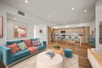 Los Angeles apartment for rent - A living room with a blue couch and a white coffee table.