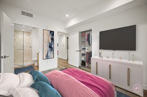 Los Angeles apartment for rent - A bedroom with a large bed and a TV on the wall.