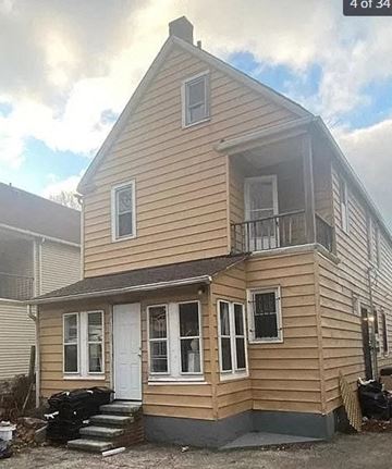 Cleveland apartment for rent - a yellow house with a porch and a white door