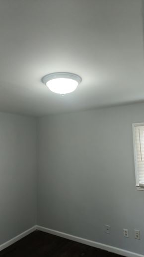Atlanta house for rent - A white ceiling light in a room with white walls and a window.
