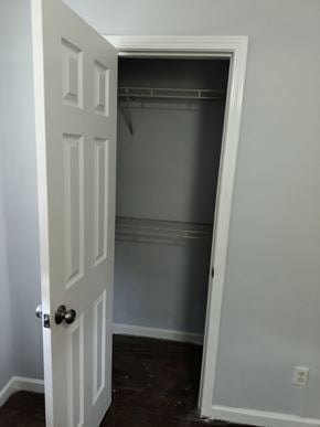 Atlanta house for rent - A white door with a silver handle is open to a dark hallway.