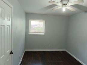 Atlanta house for rent - A room with a ceiling fan and a window.