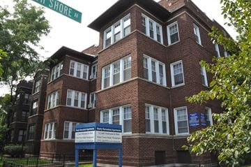 Chicago apartment for rent - a large brick building with a sign in front of it