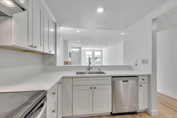 Mountain View house for rent - a white kitchen with white cabinets and a stainless steel sink