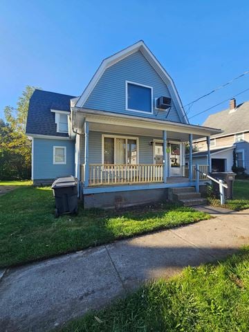 Lima apartment for rent - A blue house with a porch and a trash can in front.