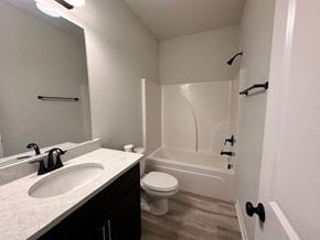 Baton Rouge house for rent - A white bathroom with a sink, toilet, and bathtub.