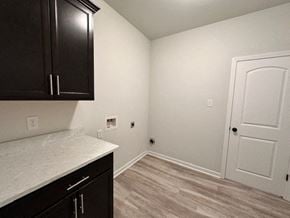 Baton Rouge house for rent - A kitchen with black cabinets and a white countertop.