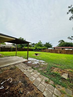 Lafayette house for rent - a yard with grass and a sidewalk and a fence