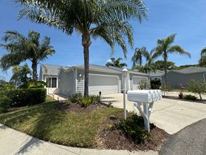 Bradenton house for rent - a house with palm trees and a mailbox in front of it